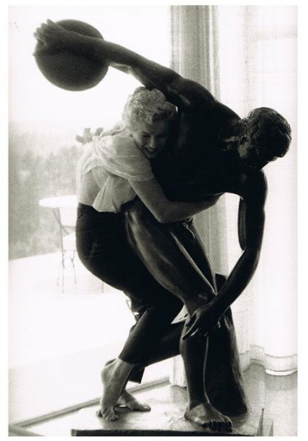 Marilyn Monroe posing with hairdresser Sidney Guilaroff's statue of the Discobolus ("Discus Thrower"). Photo by Milton Greene, 1956