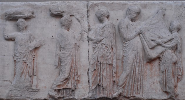 So-called "Peplos Scene" from the Parthenon frieze (panels E31-35). The scene may depict the peplos garment being folded by an Arrhephoros (?) and a chief priest.